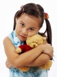 Young Girl Hugging Teddy Bear Stock Photo