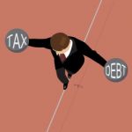 Businessman Holding Debt Weight And Tax Weight On A Wire Stock Photo