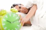 Woman In Bed With Alarm Clock Stock Photo