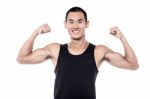 Muscular Man Flexing His Biceps Stock Photo