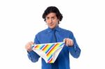Young Man Holding Underwear Stock Photo