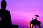 Silhouette Elephant With Tourist In Front Of Big Buddha At Sunse Stock Photo