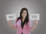 Business Young Woman Trying To Make A Decision Between Yes Or No Stock Photo