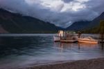 Sunlit Boats At Lake Mcdonald Stock Photo