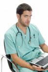Sitting Surgeon With Laptop Stock Photo