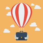 Hot Air Balloon With Suitcase Full Of Money Stock Photo