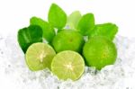 Cut Lime (citrus Aurantifolia (christm.)  Swingle) And Ice On Wh Stock Photo