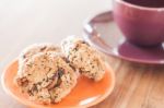 Closeup Cereal Cookies On Orange Plate And Coffee Cup Stock Photo