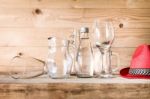 Assorted Glass Bottles On A White Washed Wooden Table. Clear Gla Stock Photo