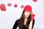 Woman With Red Hat Between Red Balls Stock Photo