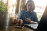 Young Asian Woman Working In Coffee Shop Stock Photo