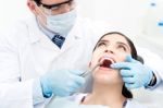 Male Dentist Treat A Woman Patient Stock Photo