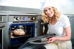 female Baker With Oven Stock Photo