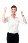 Excited Corporate Lady With Clenched Fists Stock Photo