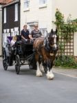 People Enjoying A Horse And Carriage Ride Through Southwold Stock Photo