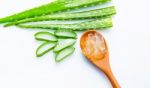 Aloe Vera Sliced Isolated On Brown Wooden Spoon On White Backgro Stock Photo