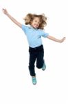 Energetic Young Child Jumping High Stock Photo