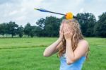 Teenage Girl Feeling Fearful With Apple And Arrow On Head Stock Photo