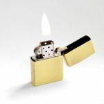 Lighter With Flame Stock Photo
