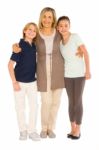 Young Grandmother With Nephew And Niece Standing On White Backgr Stock Photo