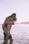 Couple Is Piggybacking On The Beach Stock Photo