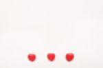 Three Red Valentine's Day Heart Shape Candy Line On White Paper Background. Love Concept. Minimalism Style. Knolling Top View Stock Photo