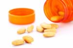 Closeup Of Orange Pills And Pill Bottle Stock Photo