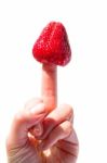 Strawberry On Finger Stock Photo