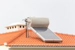 Hot Water Boiler With Solar Panel On Roof Stock Photo
