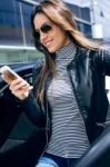 Beautiful Young Woman Using Her Mobile Phone In The Car Stock Photo