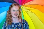 Teenage Girl Under Colorful Umbrella Stock Photo