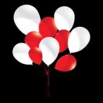 Red And White Balloons Isolated On Black Background. White And Red Balloons For Holiday And Event Stock Photo