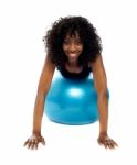 African Lady Lying On Gym Ball Stock Photo