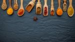 Various Of Indian Spices And Herbs In Wooden Spoons. Flat Lay Of Stock Photo