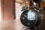 Alarm Clock On Wooden Work Table Stock Photo