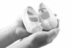 Hands Holding Baby Shoes Stock Photo