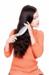 Woman Combing Her Long Black Hair Stock Photo