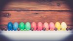 A Few Colorful Easter Eggs With Candies And Chocolate Over Wood Background Happy Easter Stock Photo