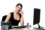Female Executive Assisting Client Over A Call Stock Photo