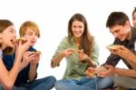 Smiling Teenagers Eating Pizza Stock Photo