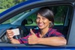 Young Woman Showing Driving License In Car Stock Photo