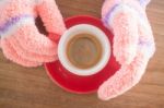 Gloved Hands Holding Cup Of Coffee Stock Photo