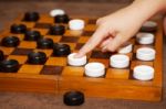 Child's Hand Moves The Piece To The Chessboard Stock Photo