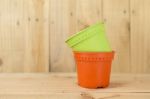 Color Plastic Pot On Wood Background Stock Photo
