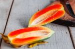 Papaya Of Half On Wooden Table Stock Photo