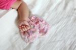 New Born Baby Hand With Pink Color Gloves Stock Photo
