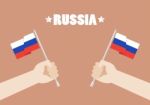 Hands Holding Up Russia Flags Stock Photo