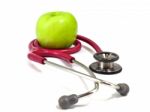 Stethoscope And Fresh Green Apple On White Background. Healthy F Stock Photo