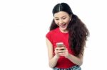 Excited Pretty Girl Sending A Text Message Stock Photo