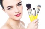 Pretty Girl With Makeup Brushes Near Her Face Stock Photo